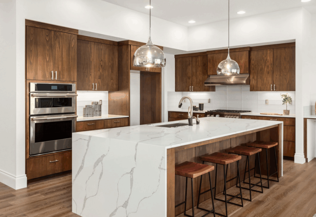 Kitchen island with brown wood cabinets and white countertops